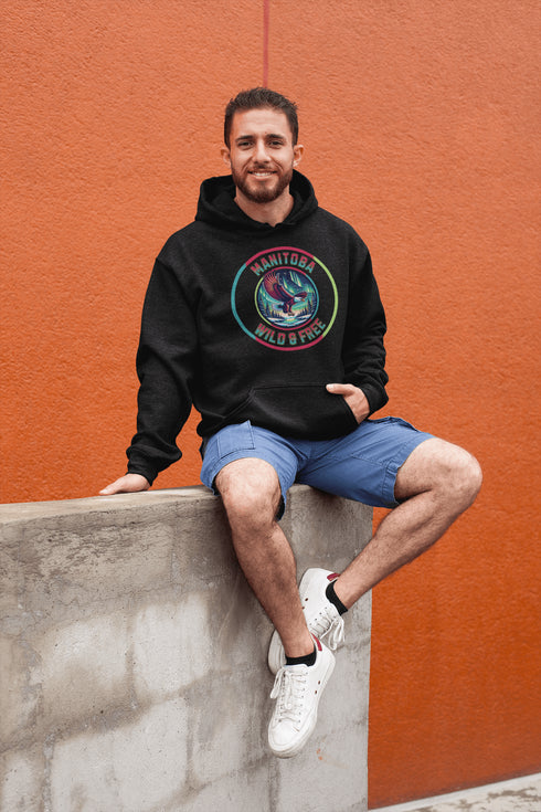 Soar high in our Manitoba – Wild & Free hoodie, featuring a bold flying bald eagle beneath the captivating northern lights.